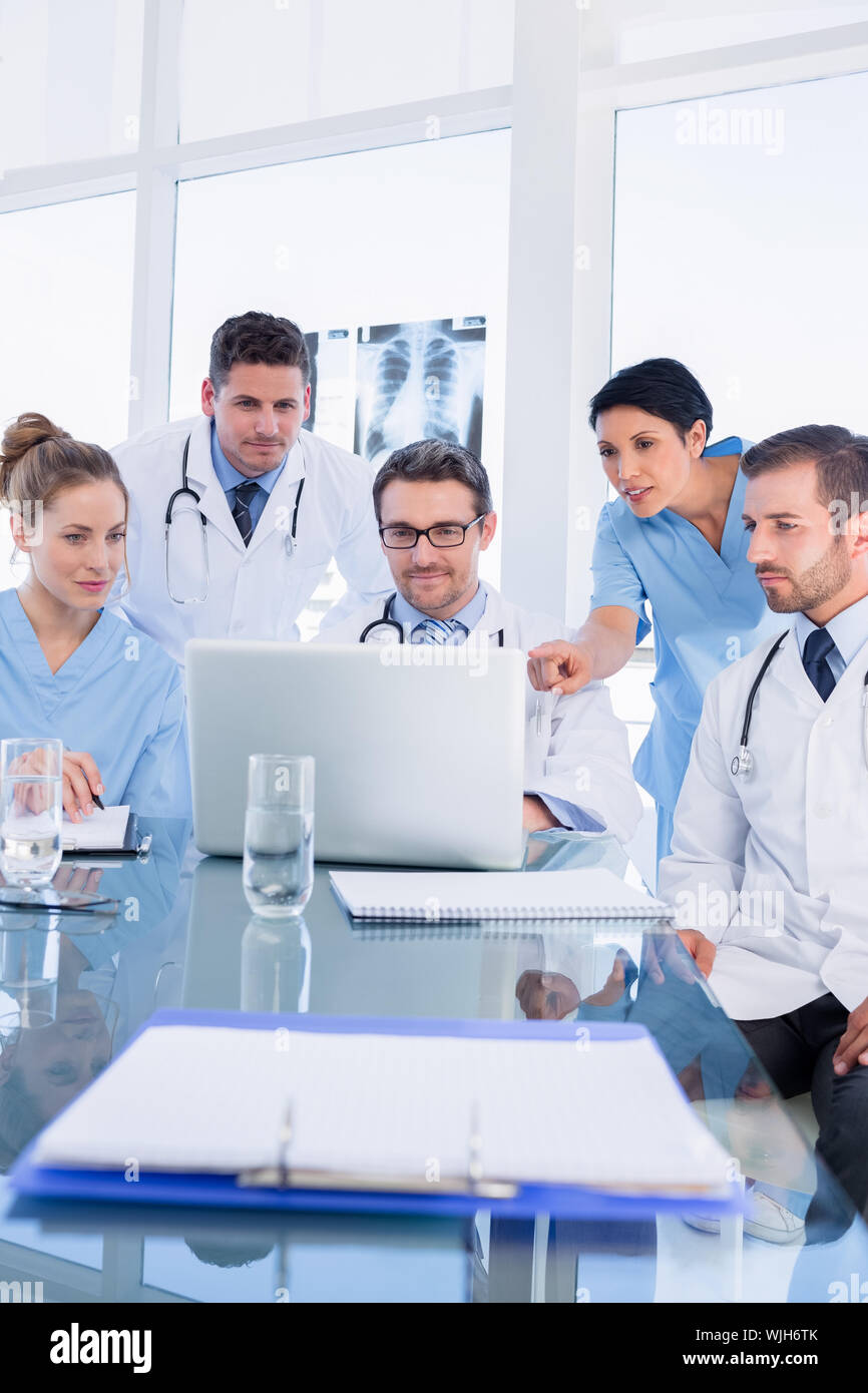 Concentrated medical team using laptop together in the office Stock ...