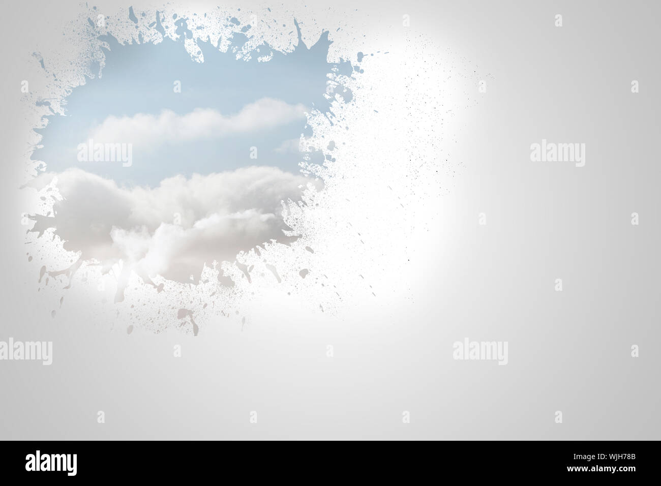 Splash on wall revealing clouds Stock Photo