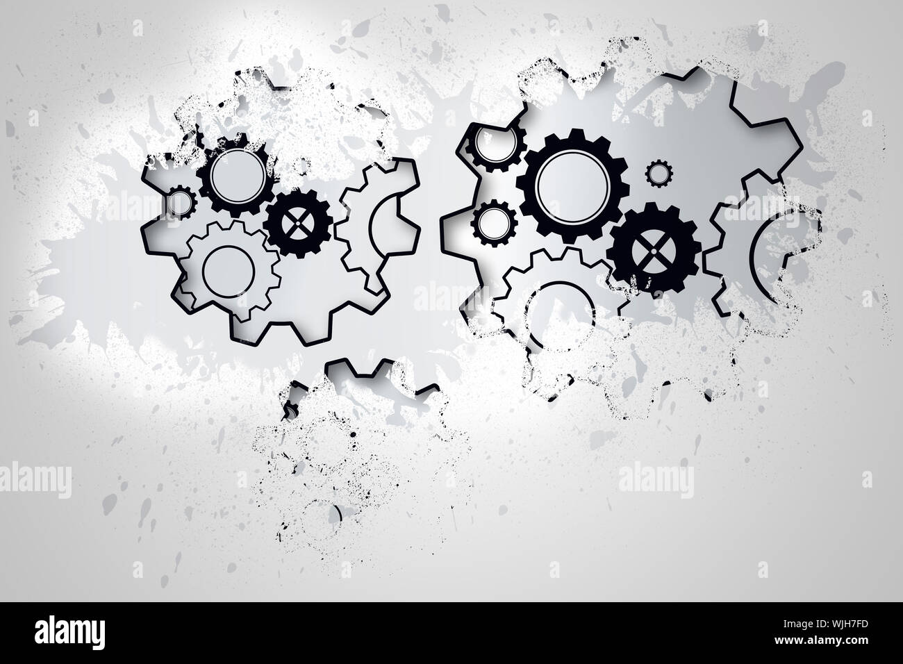 Splash on wall revealing cogs and wheels Stock Photo