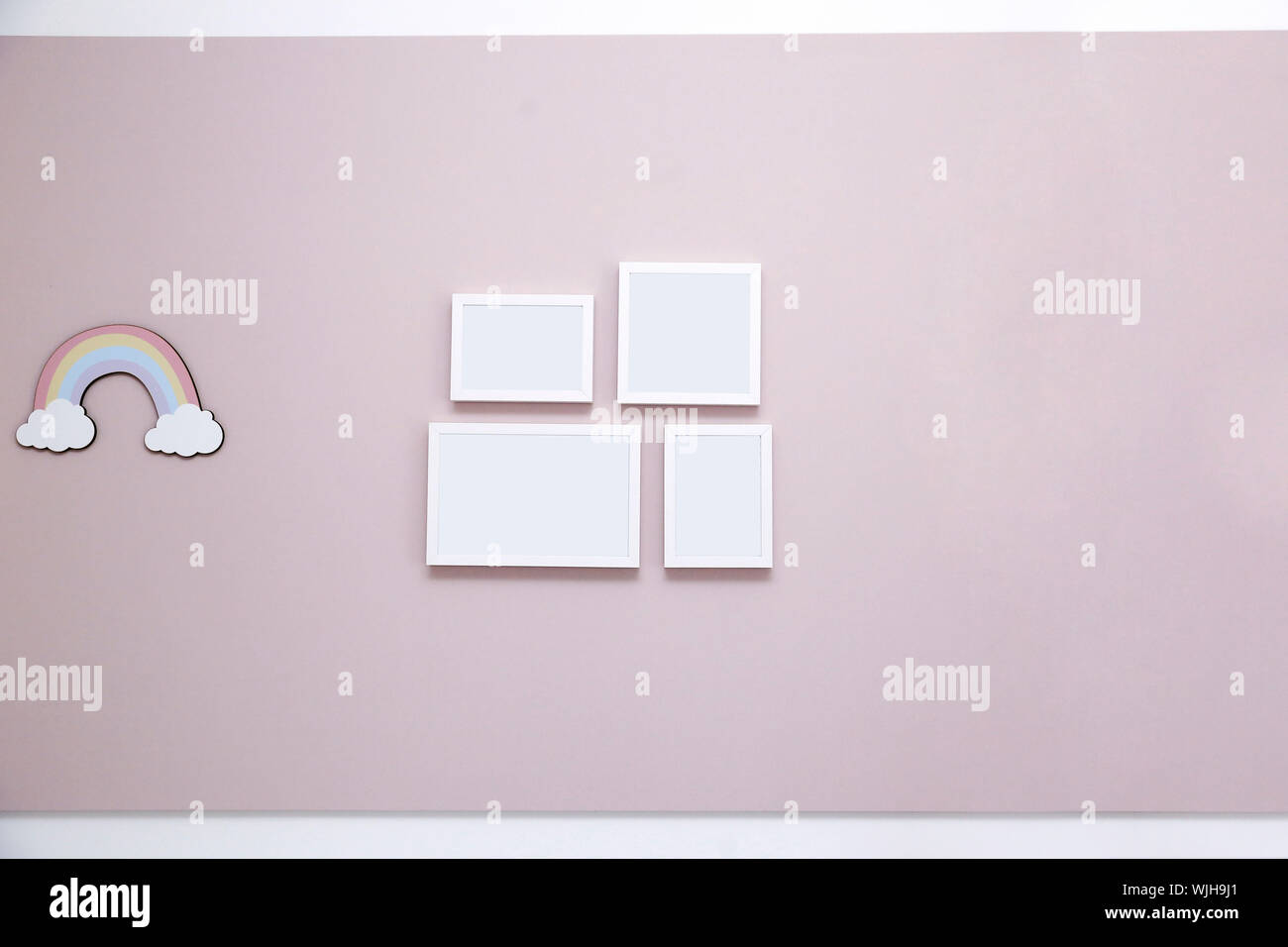 Light pink panel on wall with mockup frames - Girl's kids room - Pink wall in kids room for girl Stock Photo