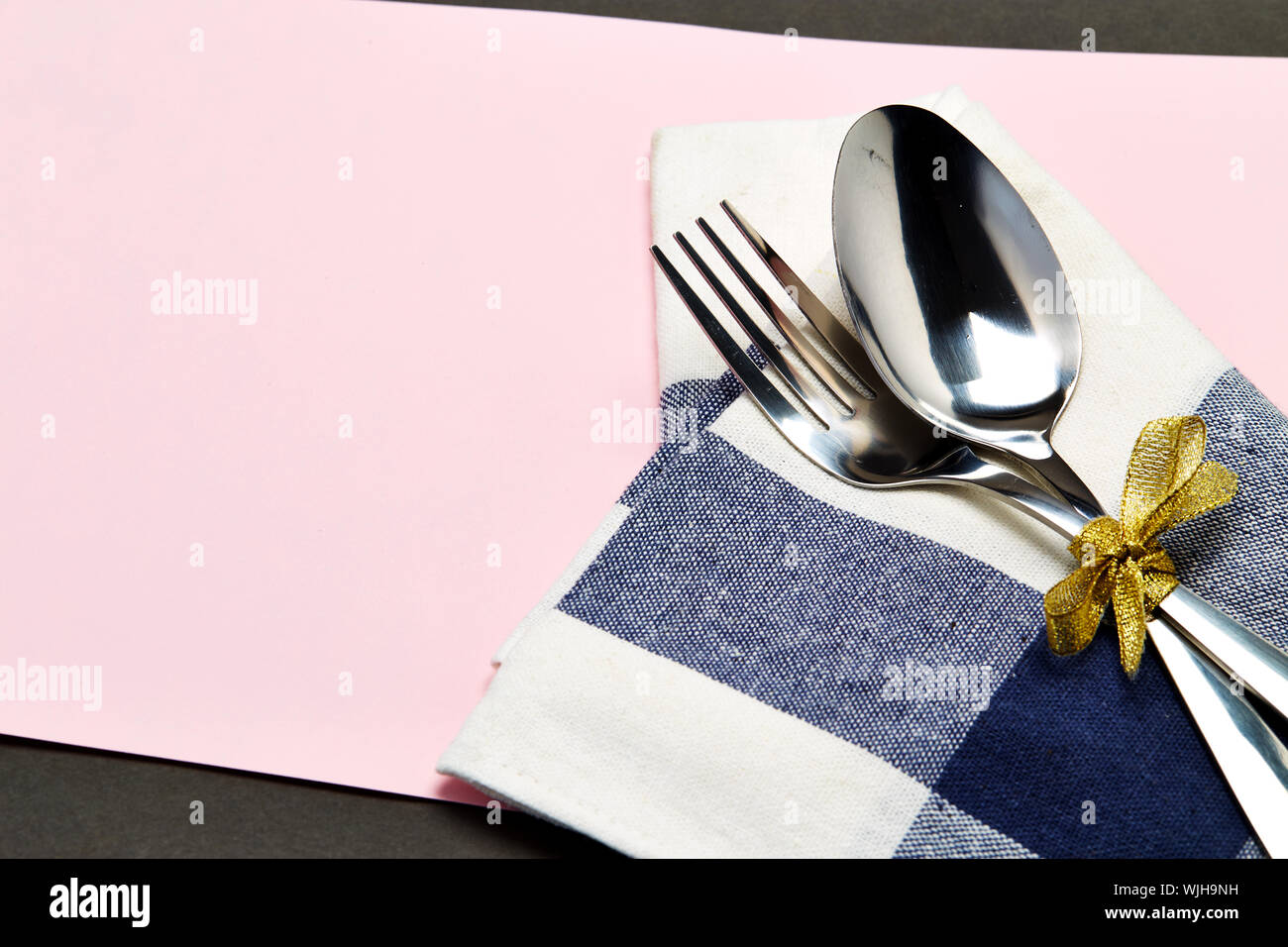 Close-up Of Cutlery With Napkin On Table Stock Photo
