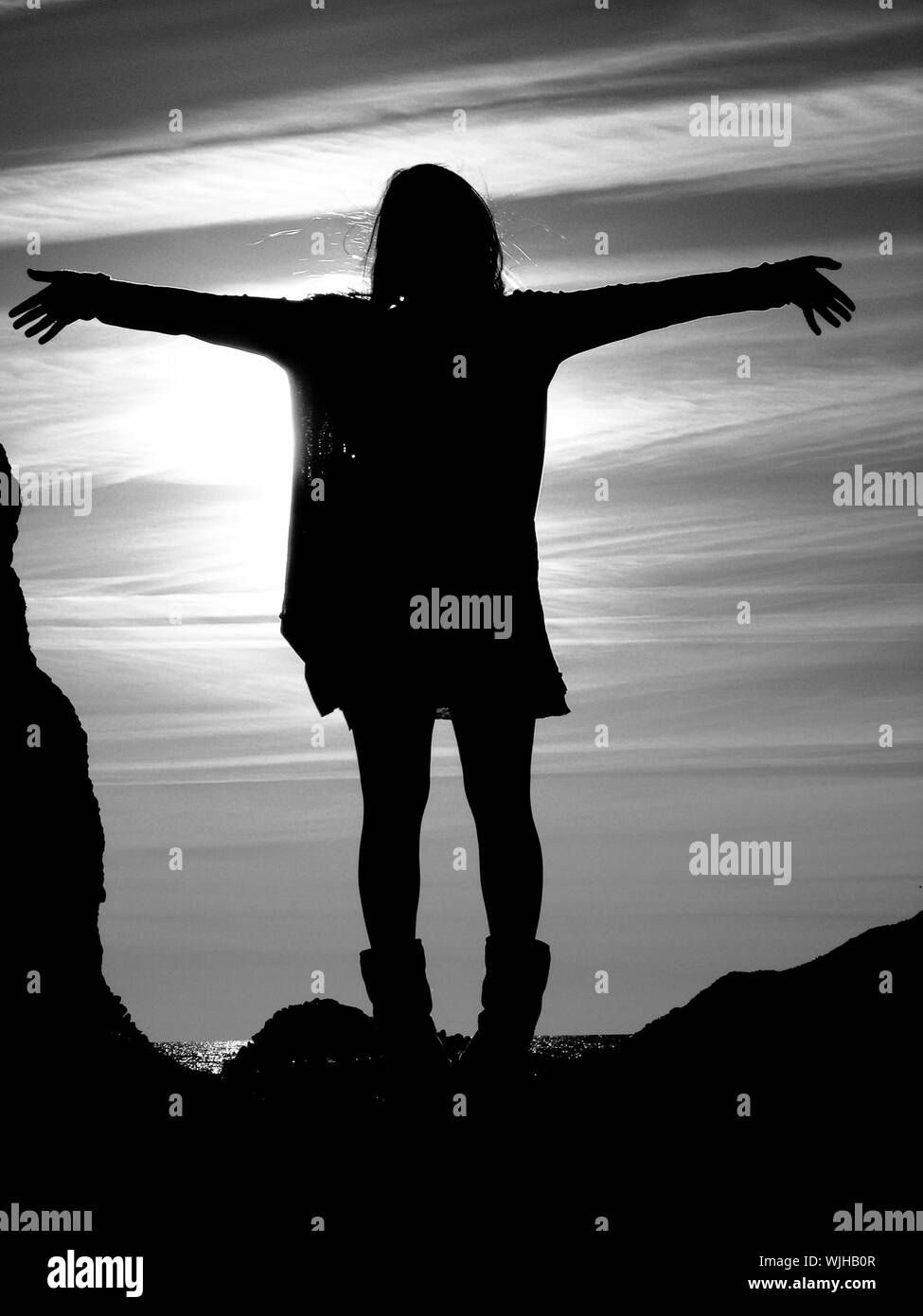 Girl standing with outstretched arms Black and White Stock Photos ...