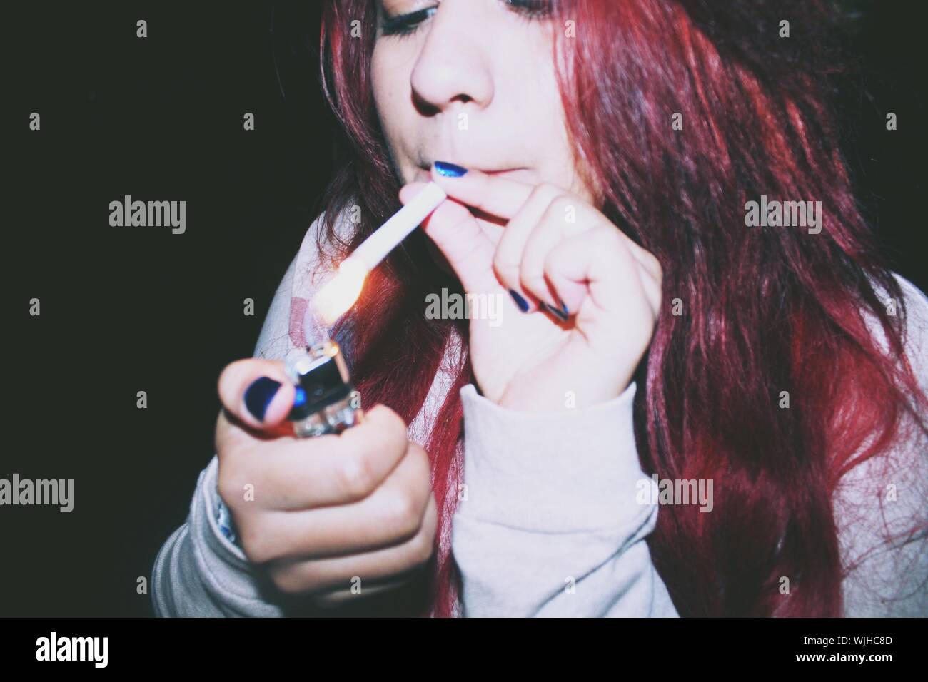 Woman lighting cigarette hires stock photography and images Alamy