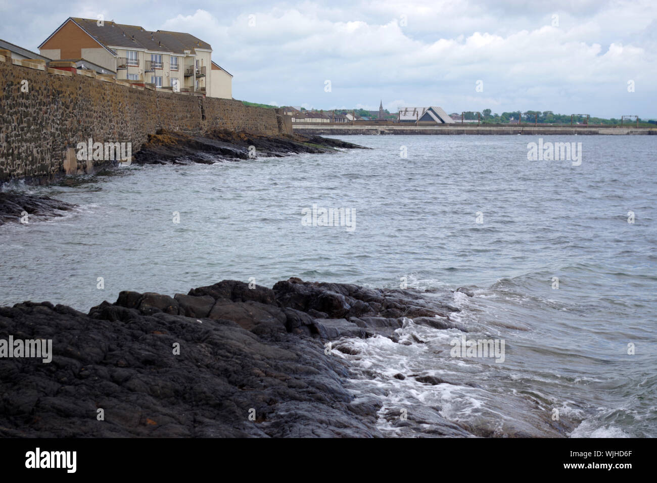 The tide is in on the rocks at Saltcoats. Saltcoats is a small town on the west coast of North Ayrshire, Scotland. Stock Photo