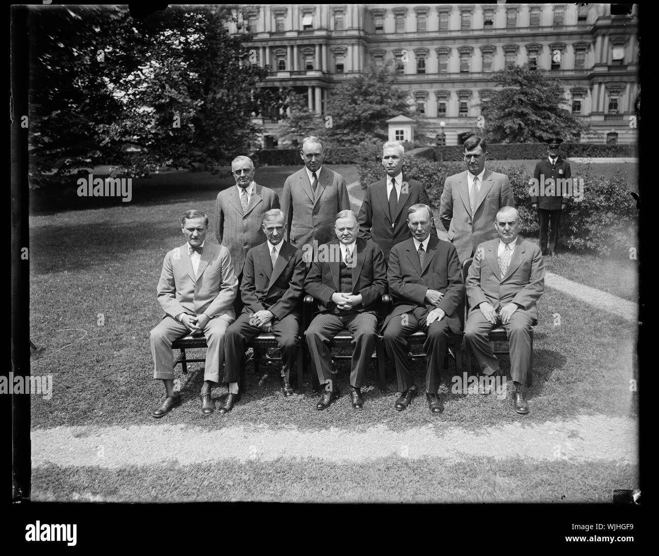 Herbert Hoover and group; State, War, and Navy building in background, Washington, D.C. Stock Photo