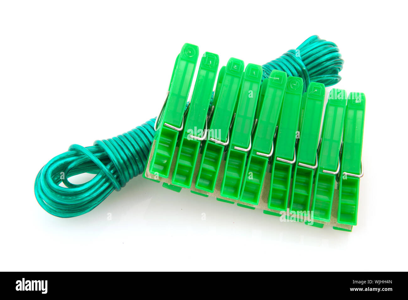 Green plastic clothes pegs and laundry line Stock Photo