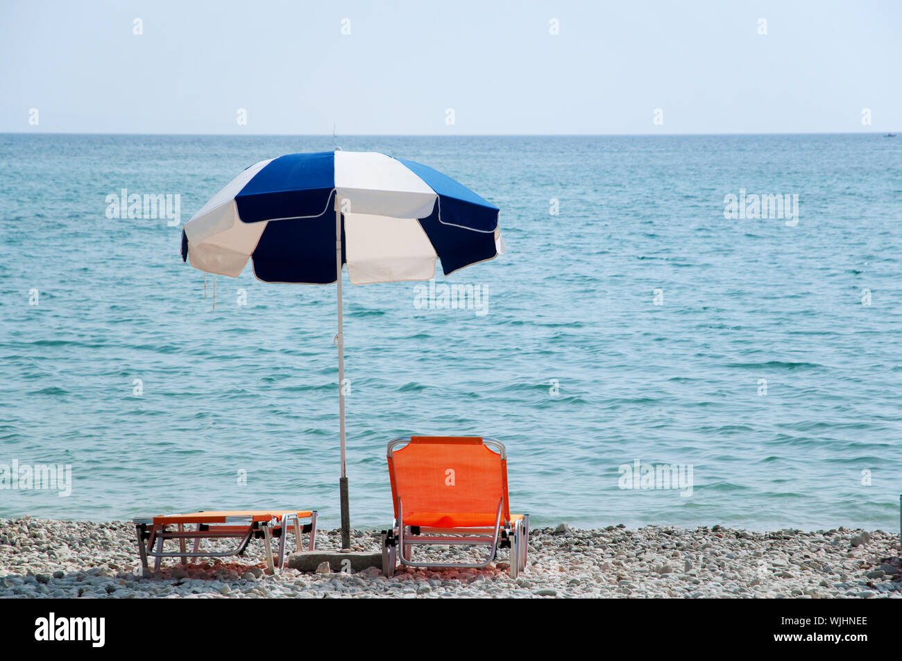 Blue and white parasol at the beach Stock Photo Alamy