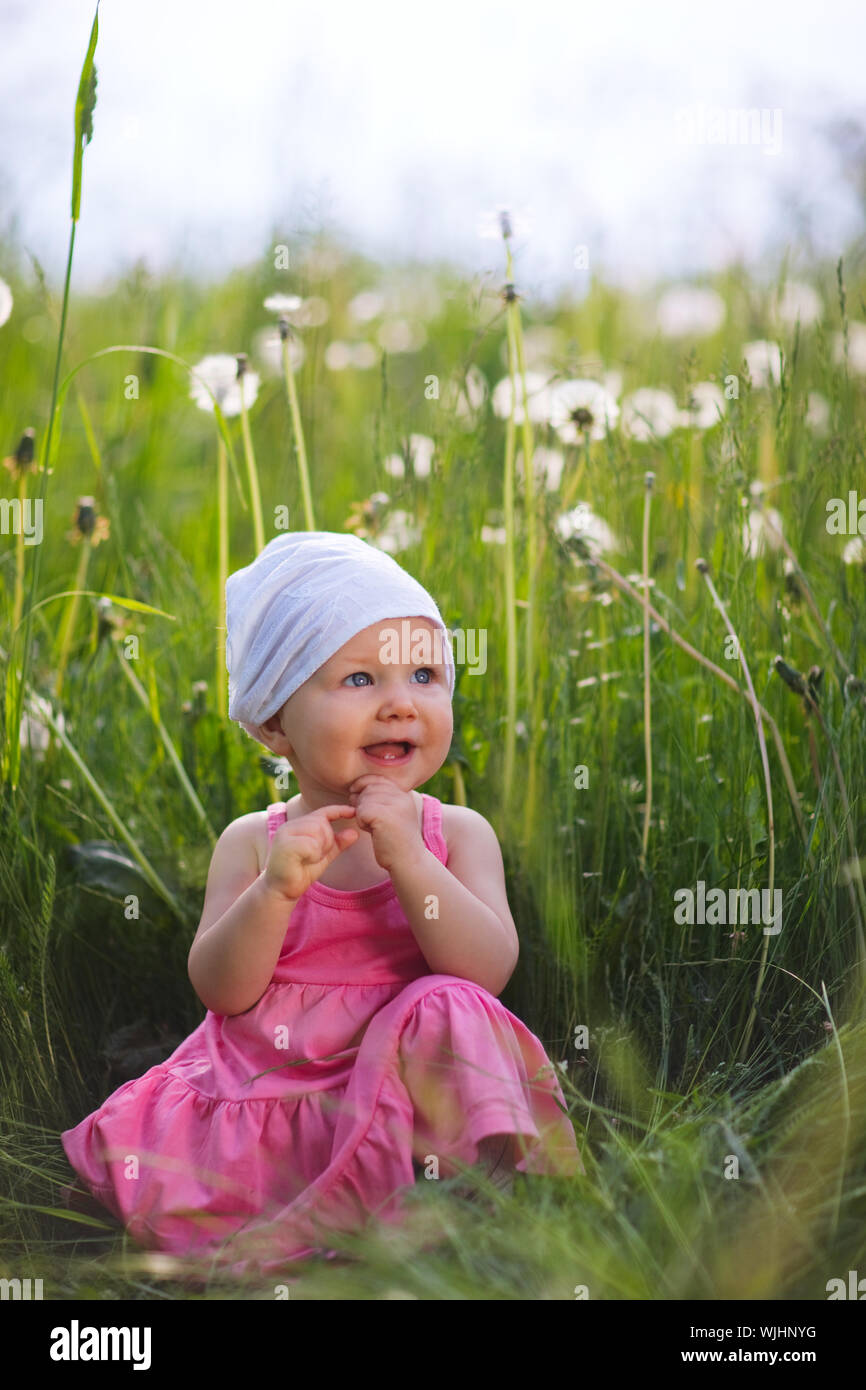 Cute little girl in meadow at sunny summer day Stock Photo - Alamy