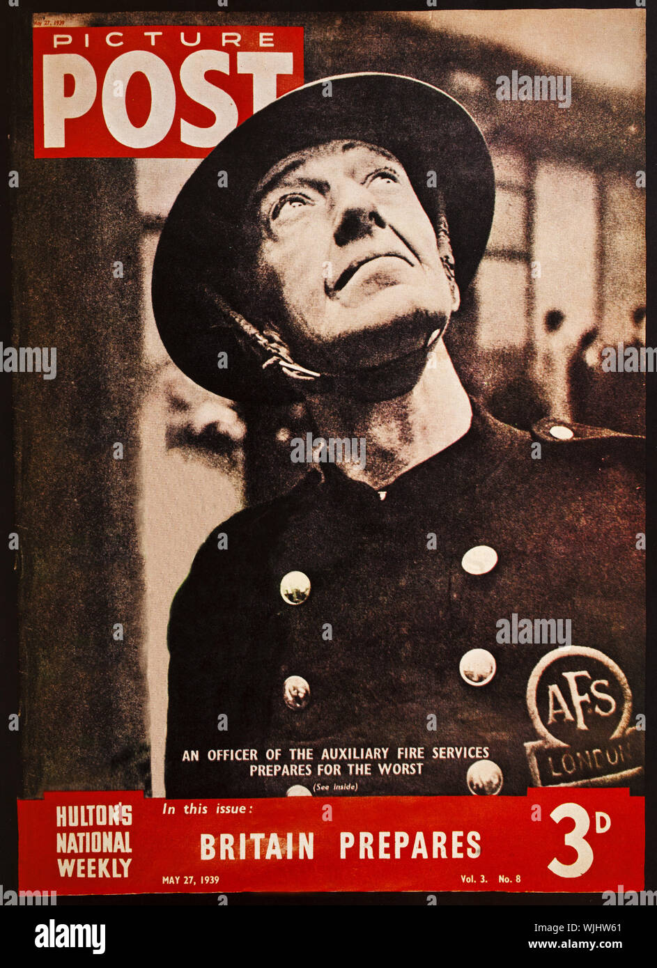 A cover fromPicture Post from May, 1939, featuring an Auxiliary Fire Man looking skywards apprehensively and fearing the worst from the anticipated air raids from the German Luftwaffe. The raids and the London Blitz began on the 7th September 1940. Stock Photo