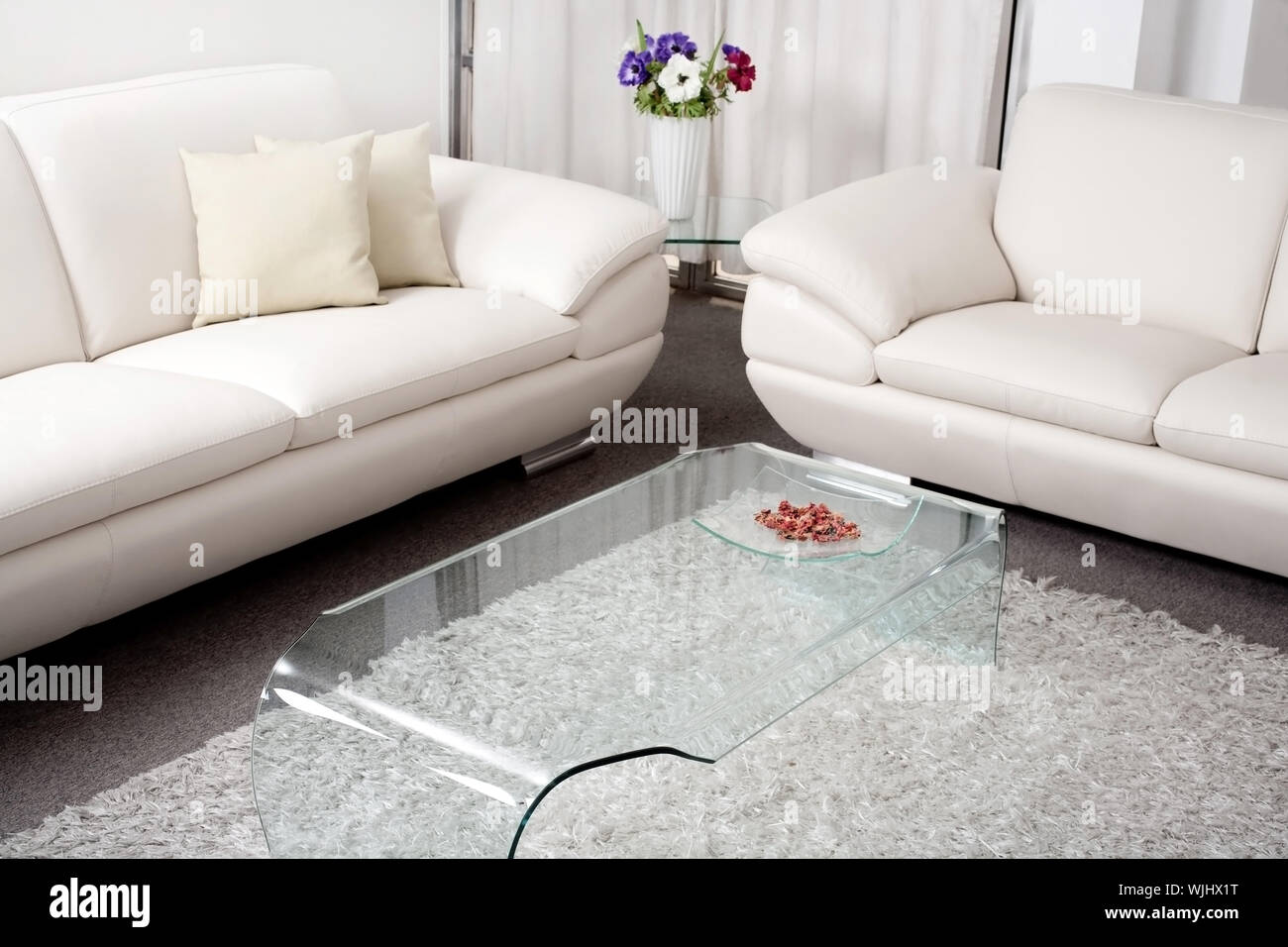 Modern white leather couch in living room Stock Photo - Alamy