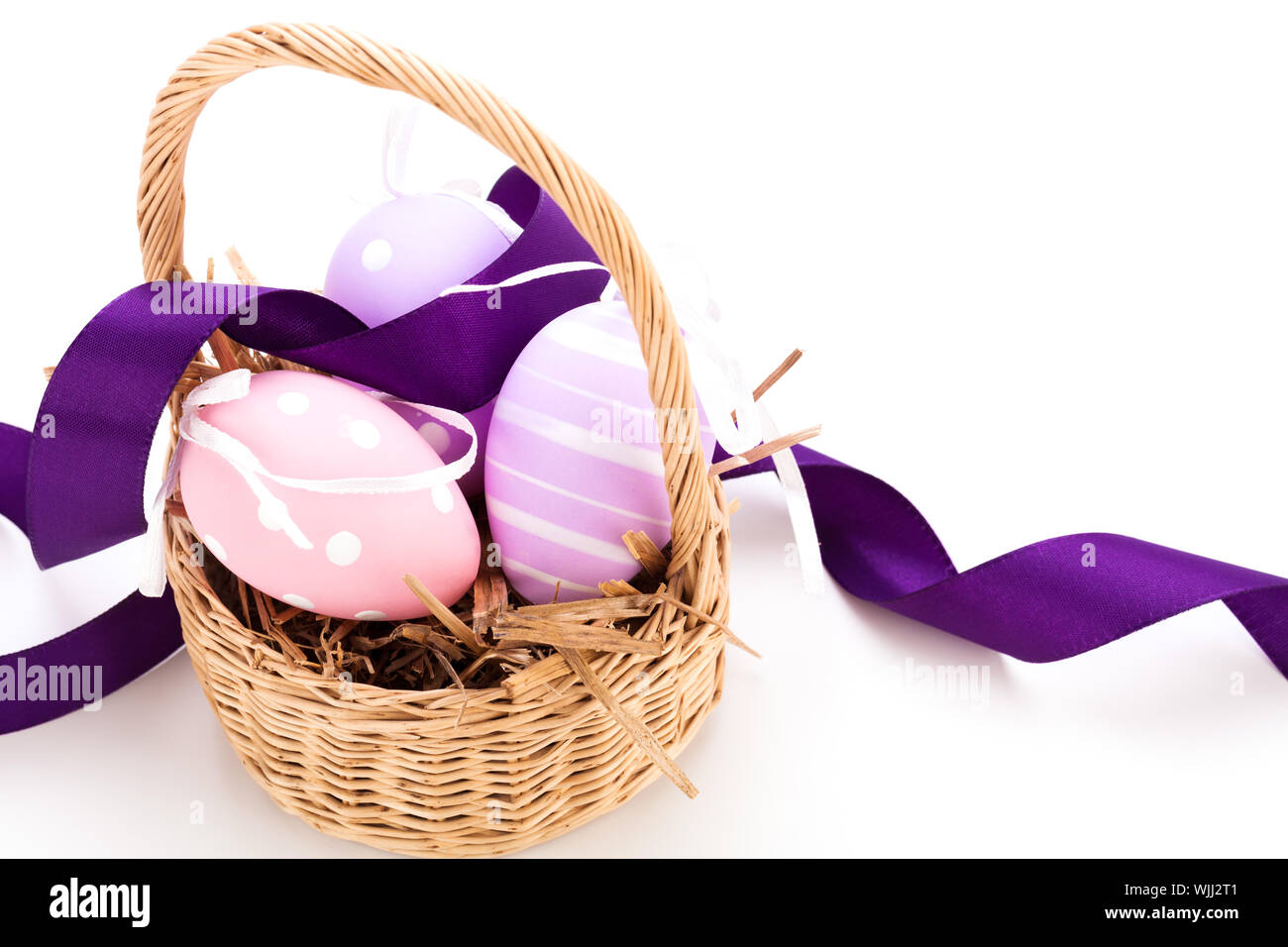 Straw basket with traditional Easter eggs Stock Photo