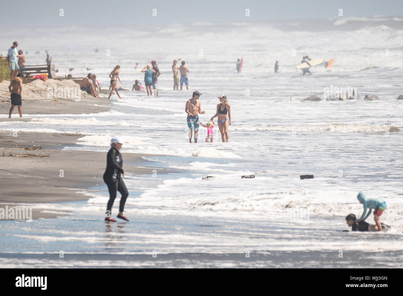 Folly Beach, South Carolina, USA. 03 September 2019. Beach goers ignore the mandatory evacuation order and crowd the washout as waves roll in ahead of Hurricane Dorian September 3, 2019 in Folly Beach, South Carolina. The slow moving monster storm devastated the Bahamas and is expected to reach Charleston as a Category 2 by Thursday morning.  Credit: Richard Ellis/Alamy Live News Stock Photo