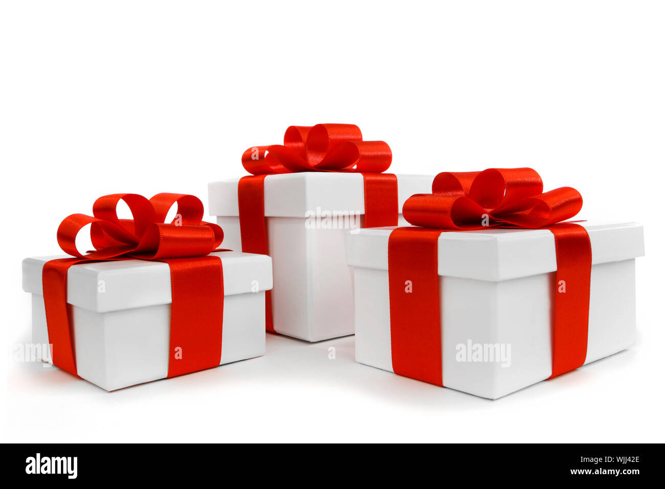 Gift boxes with red ribbon bows on white background Stock Photo - Alamy