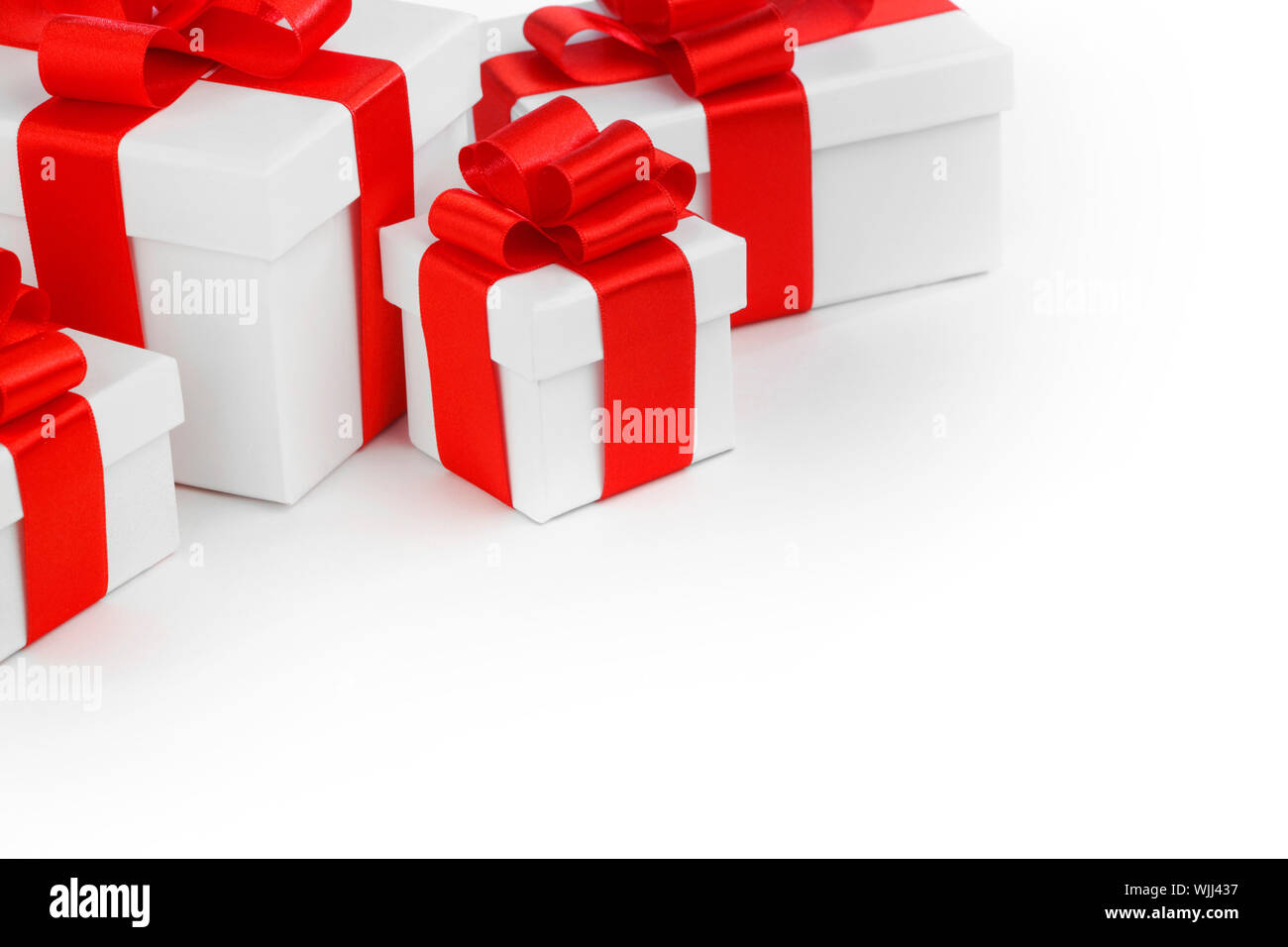Gift boxes with red ribbon bows on white background Stock Photo - Alamy