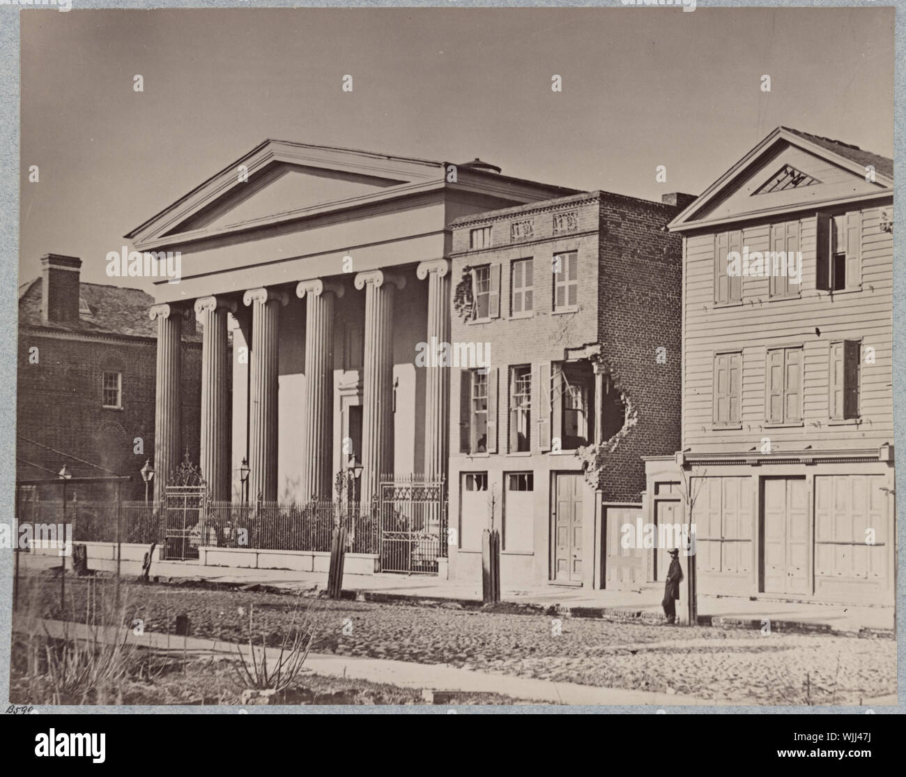 Hibernian Hall, Charleston, S.C Abstract: Photograph shows shell damaged buildings on Meeting Street with Hibernian Hall on the left. Stock Photo