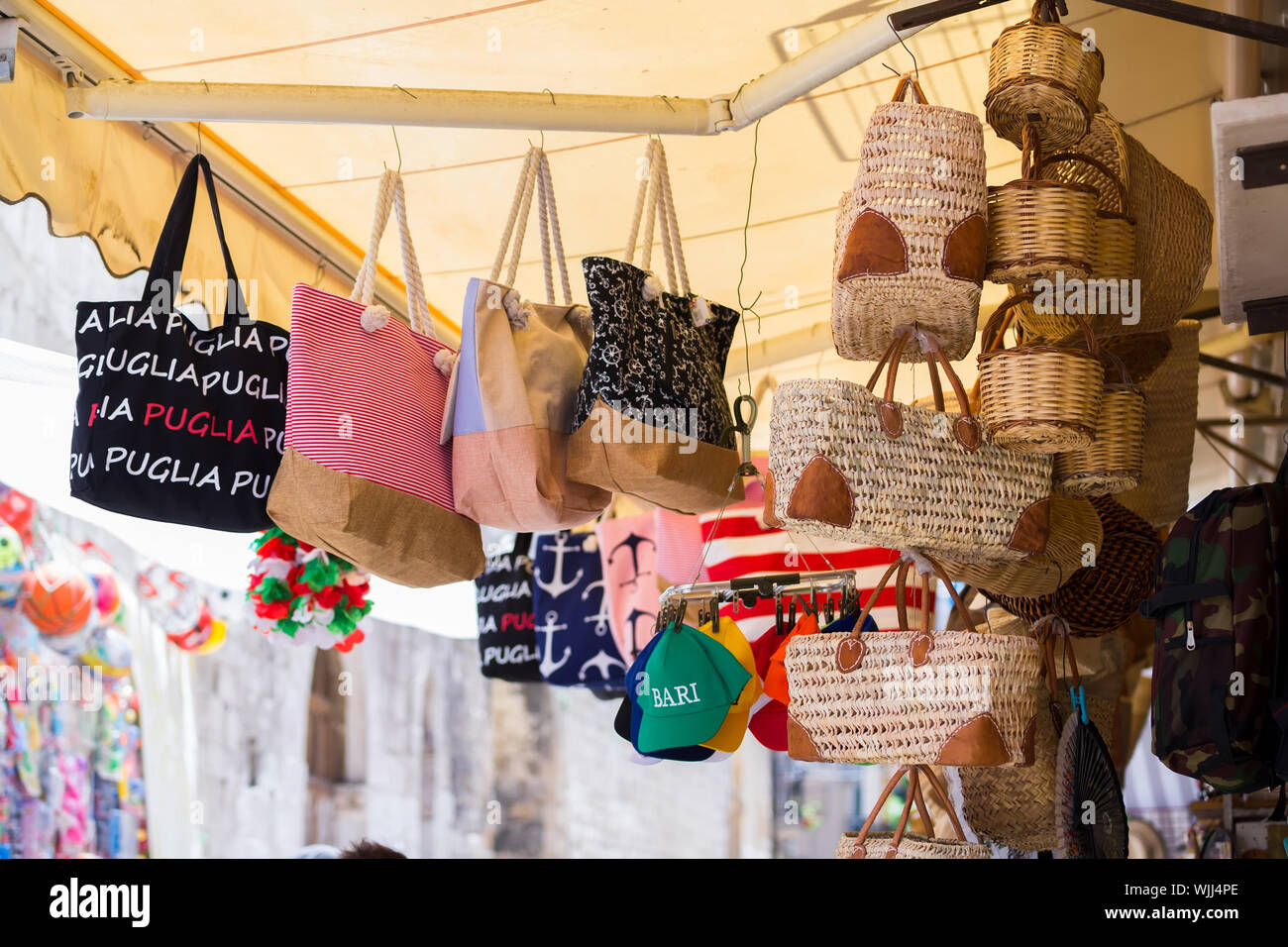 BARI, ITALY - JULY 11, 2018, View of a narrow street in Bari, Puglia, Italy, Bari vecchia, traditional open market shops with souvenir for tourists Stock Photo