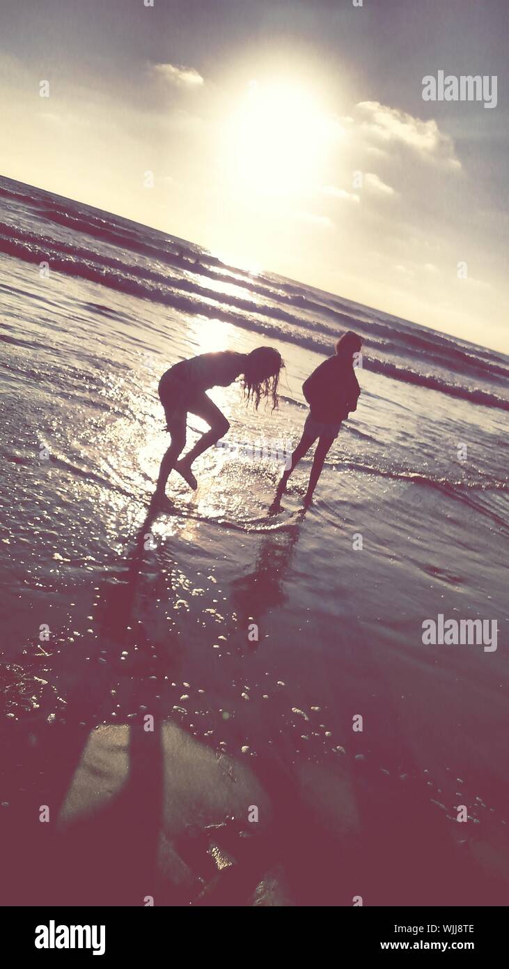 Silhouette of two women on the beach hi-res stock photography and ...
