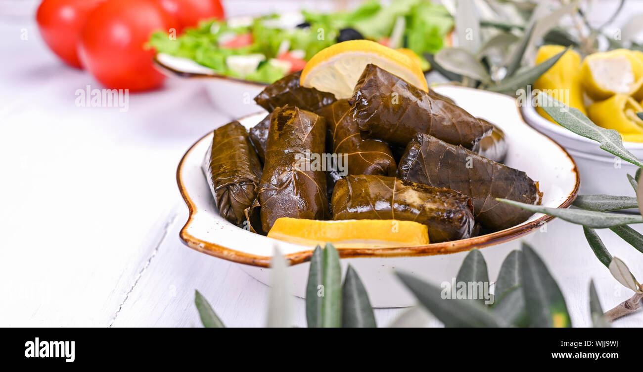 Traditional greek cuisine. Wrapped rice in grape leaves. Dolma with