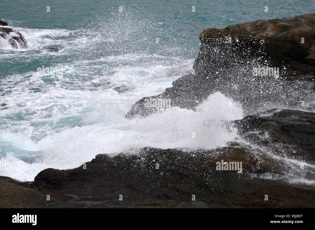 Waves Breaking On Rocks Stock Photo