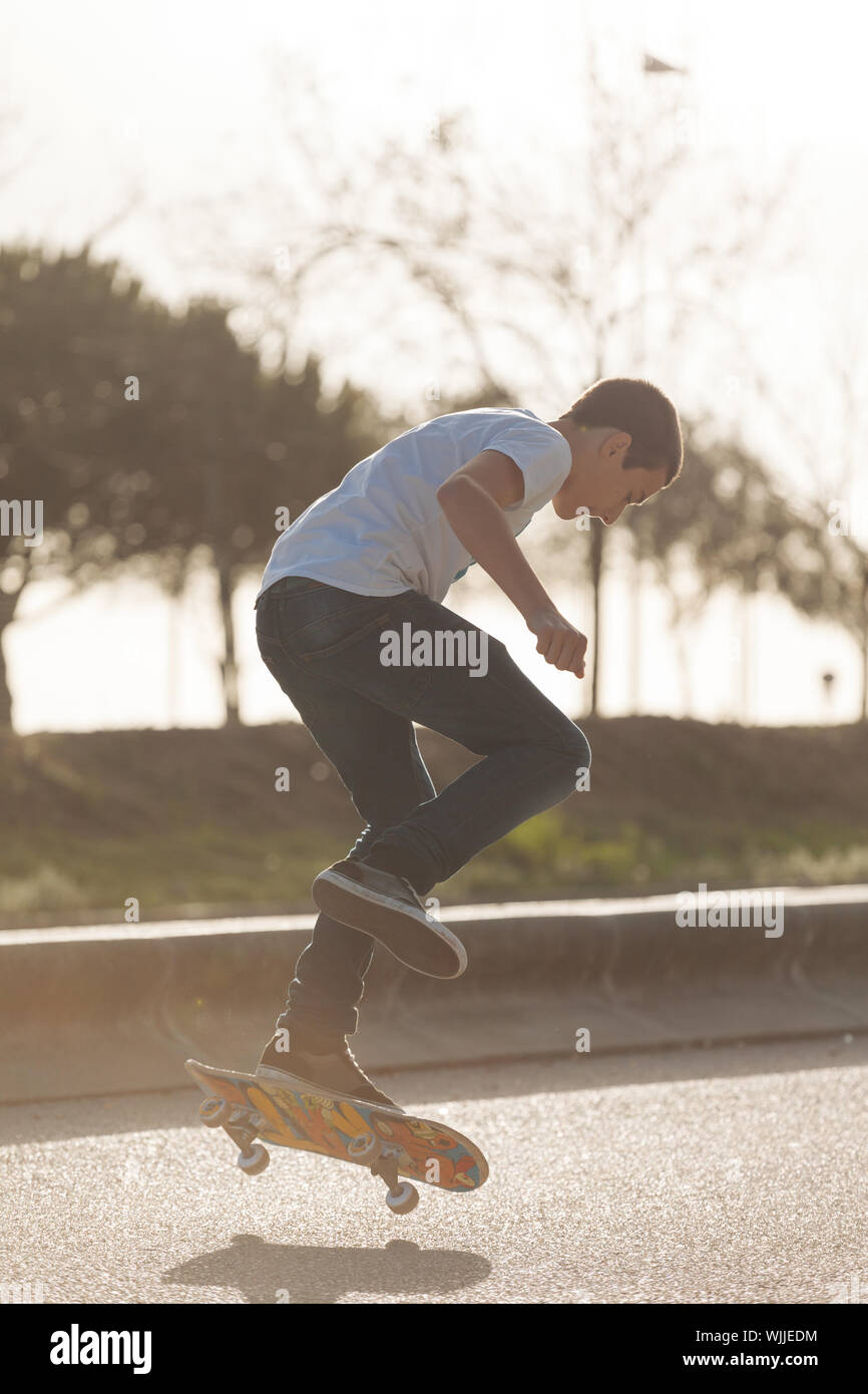 Teenage Boy Skateboarding On Street Stock Photo - Alamy