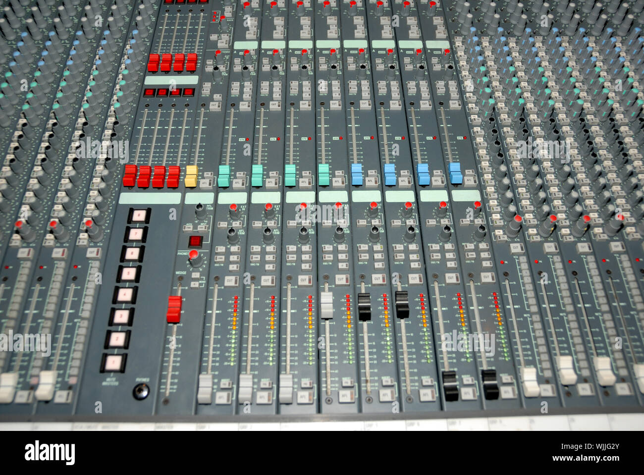Audio mixing console in a recording studio. Faders and knobs of a sound ...