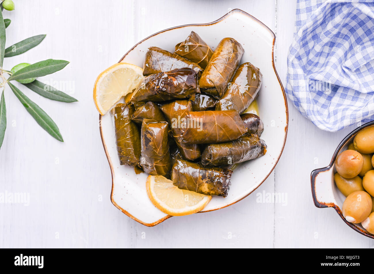 Traditional greek cuisine. Wrapped rice in grape leaves. Dolma with lemon and spices. Home