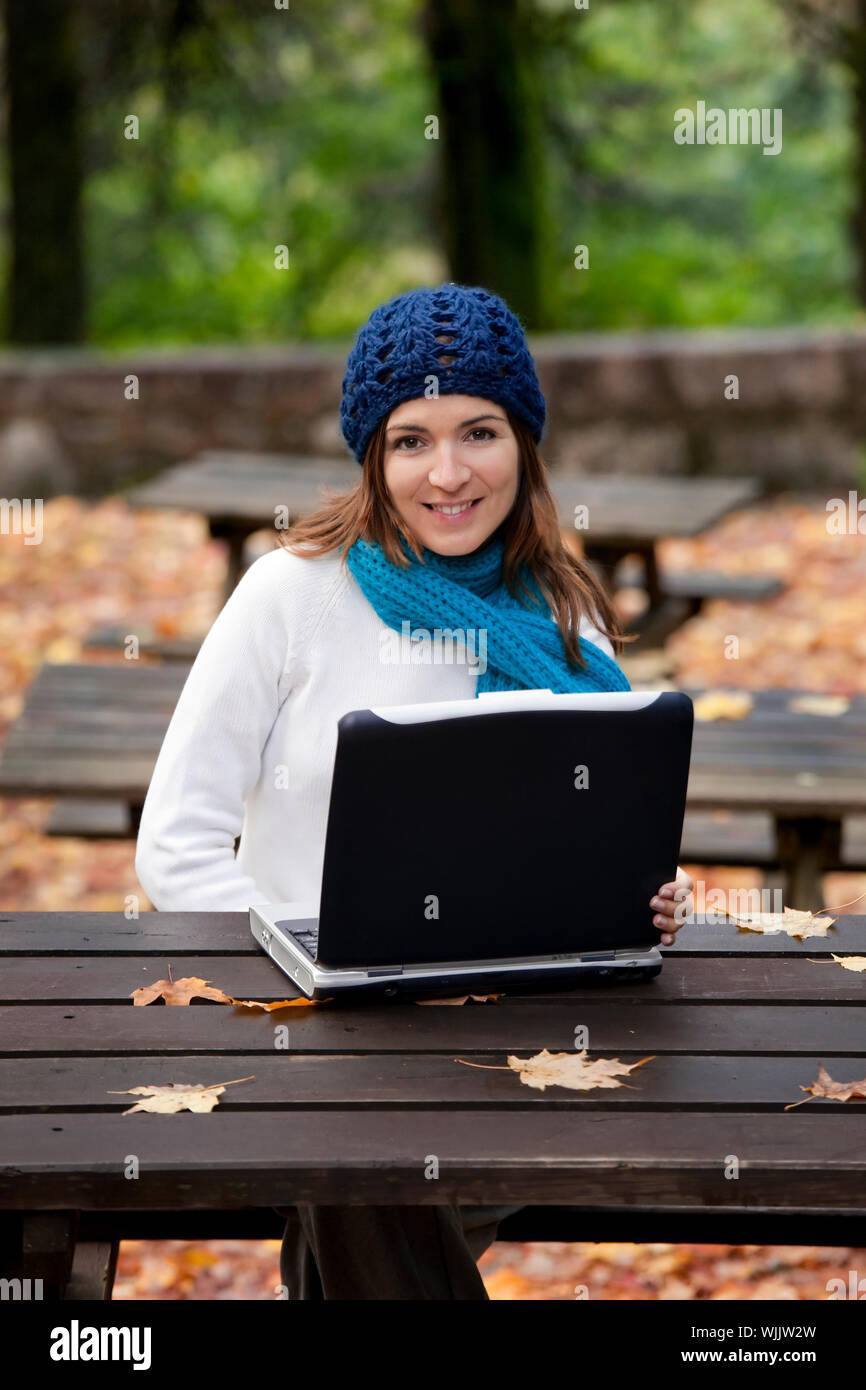 Beautiful young woman in the park working with a laptop Stock Photo - Alamy