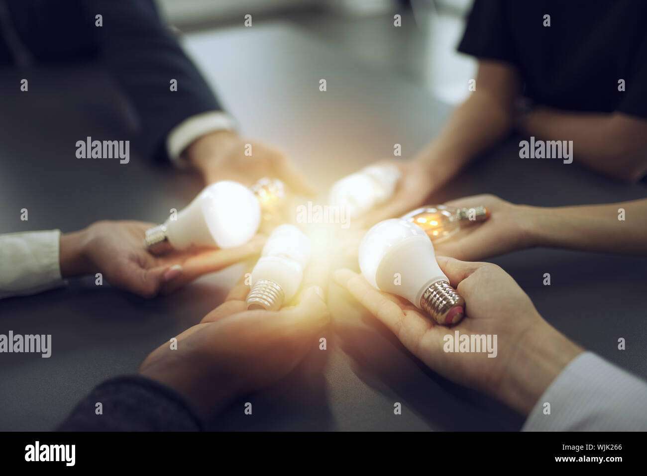 Teamwork and brainstorming concept with businessmen that share an idea with a lamp. Concept of startup Stock Photo