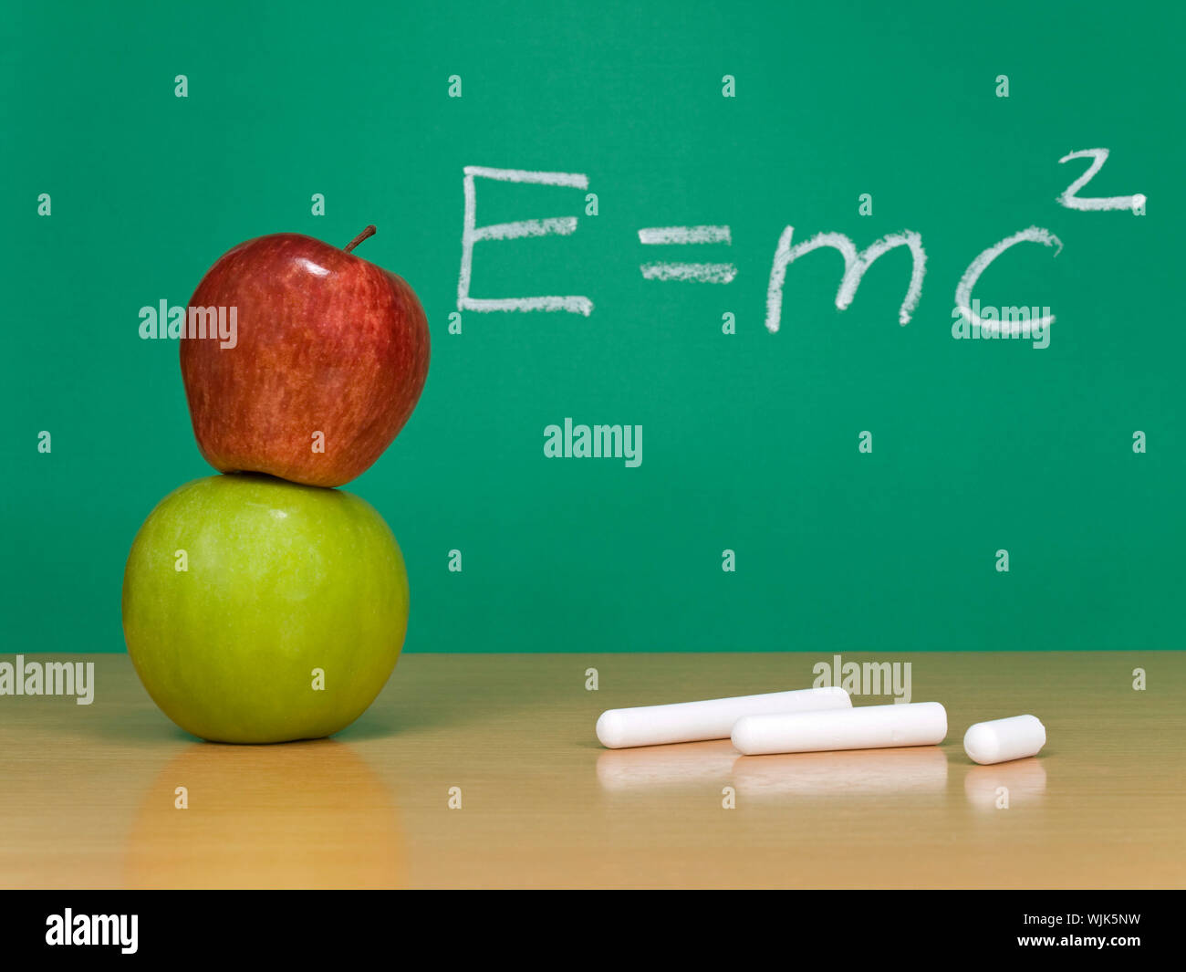 Einsteins formula of theory of relativity on a chalkboard. Some chalks