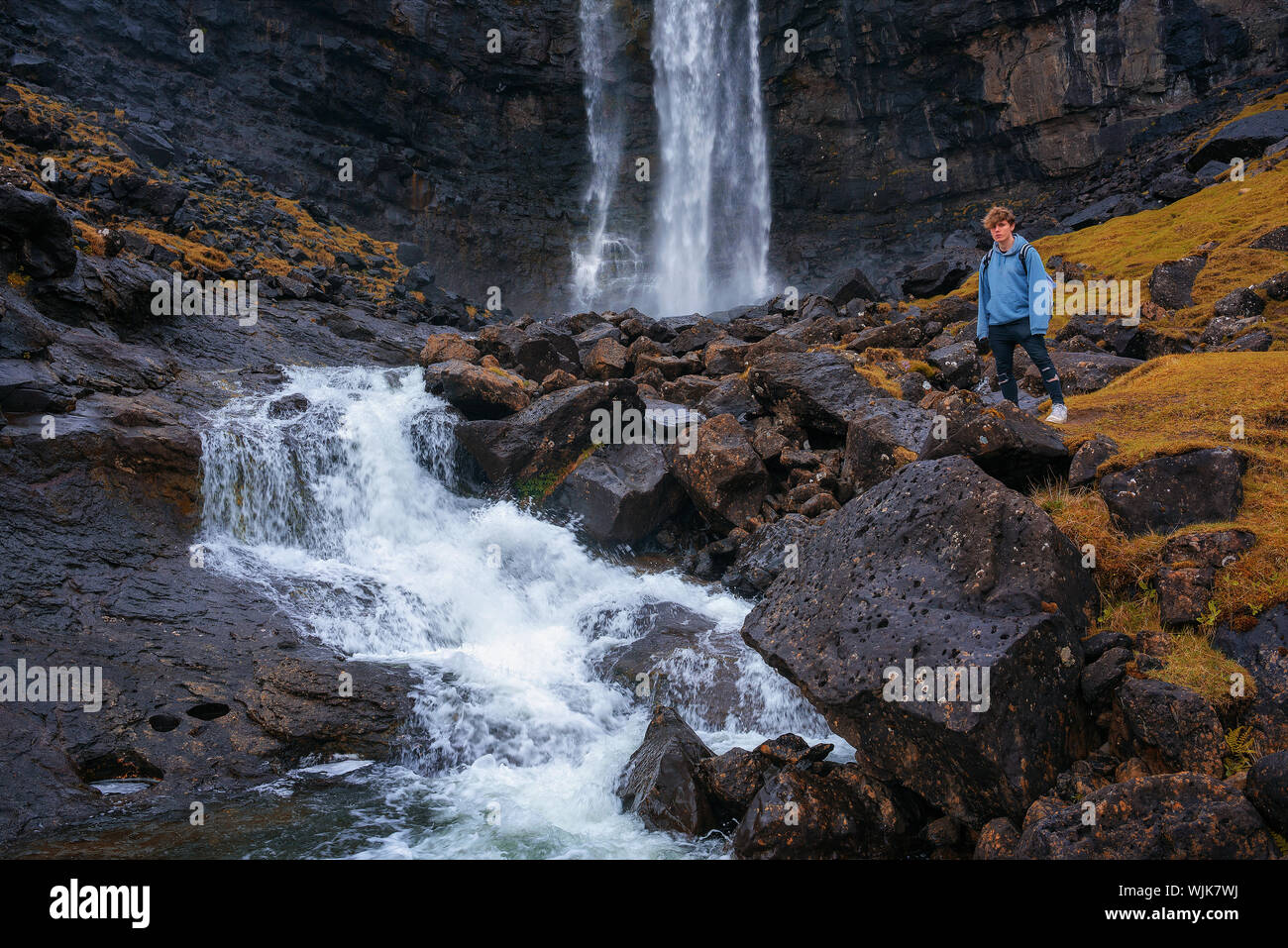 Tourist at the Fossa Waterfall on island Bordoy in the Faroe Islands Stock Photo