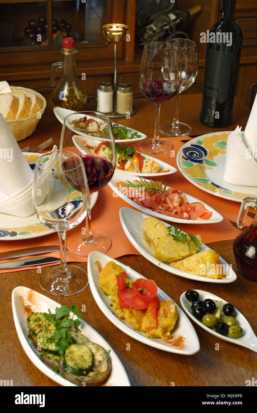 A table setting full of traditional Spanish tapas and wine Stock Photo