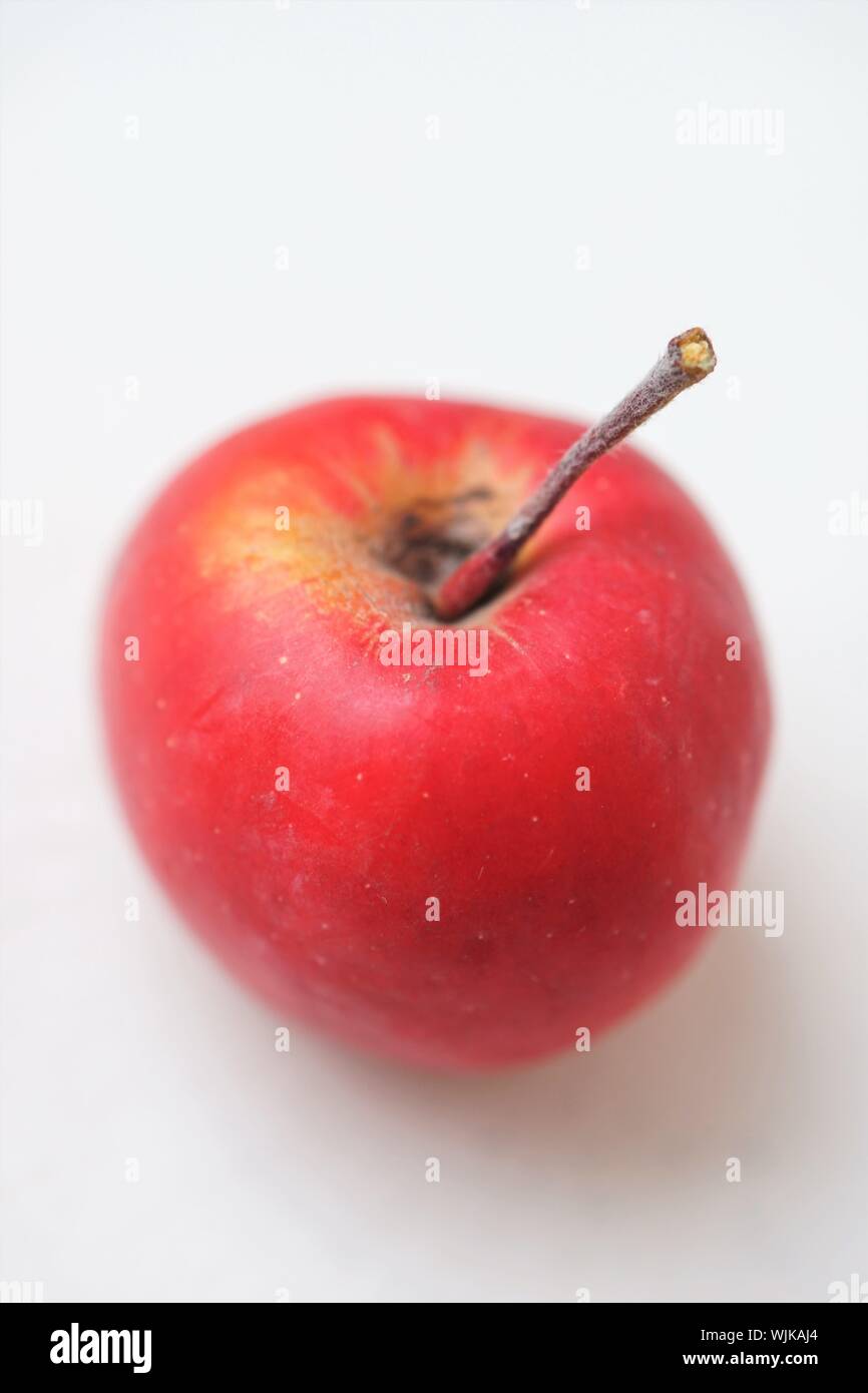 ripe red apple on the white table, closeup, selective focus Stock Photo