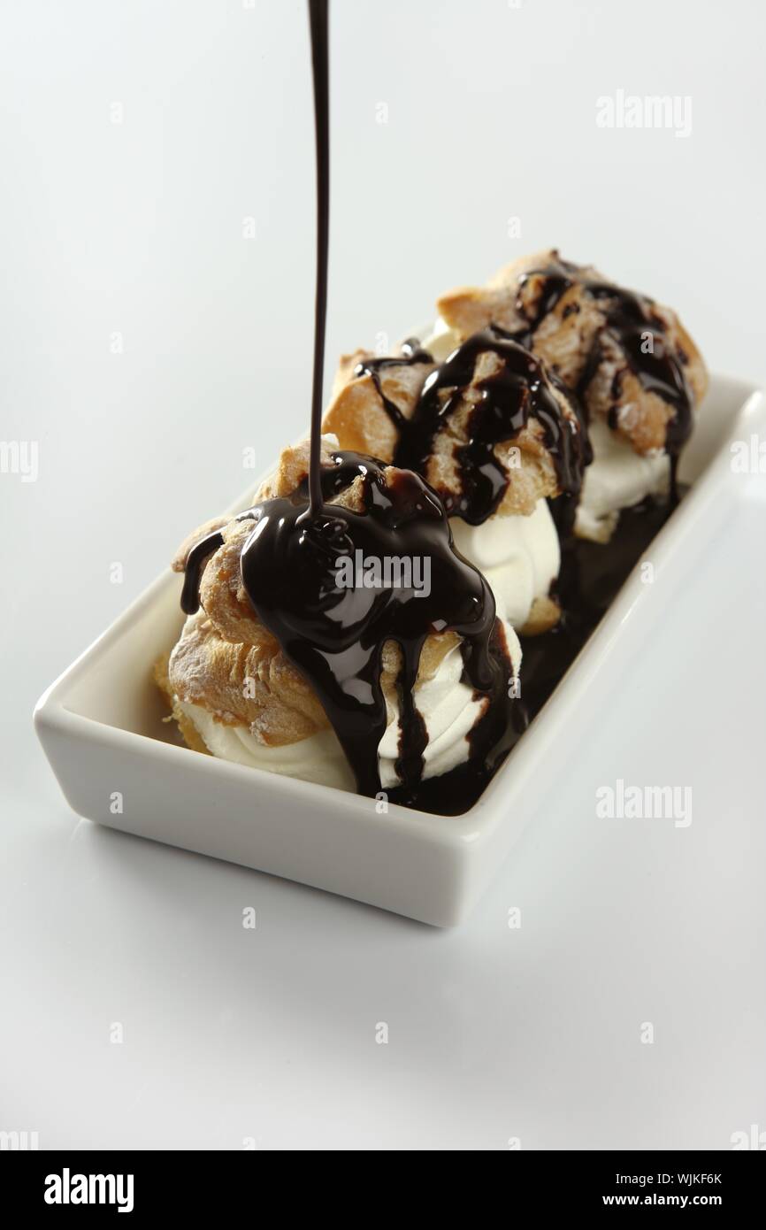 Delicious and addictive cream puff cake dessert with chocolate syrup