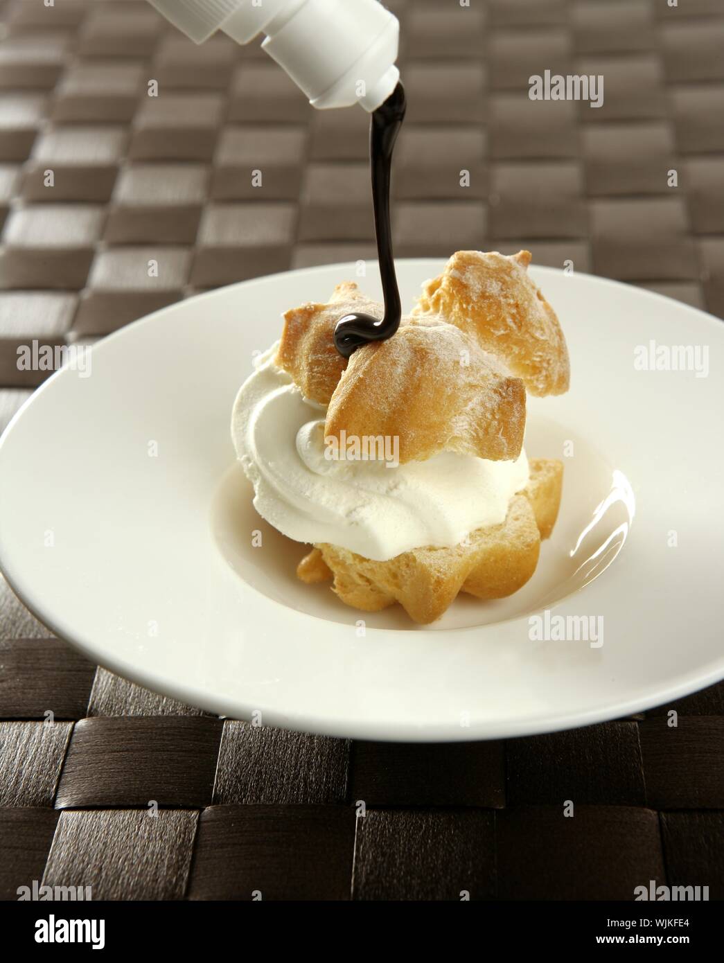 Delicious and addictive cream puff cake dessert with chocolate syrup