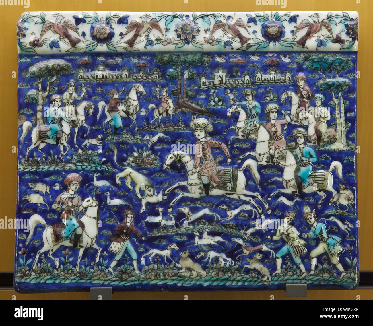 Hunting scene depicted in the Persian glazed tile dated from the18th or 19th century on display in the Museum of Fine Arts (Musée des Beaux-Arts de Lyon) in Lyon, France. Stock Photo