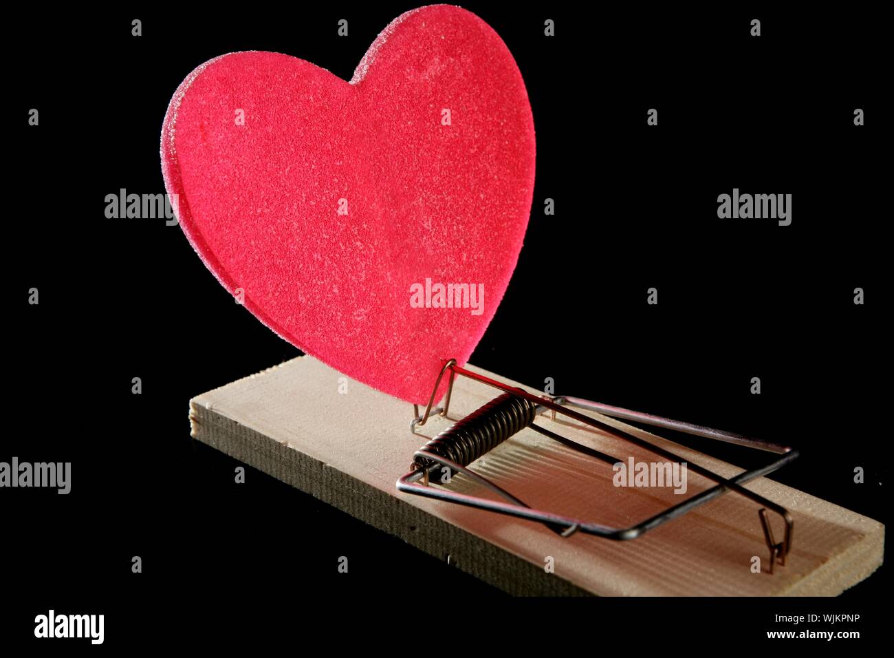 https://c8.alamy.com/comp/WJKPNP/love-and-health-as-a-mouse-trap-metaphor-with-red-candy-heart-WJKPNP.jpg