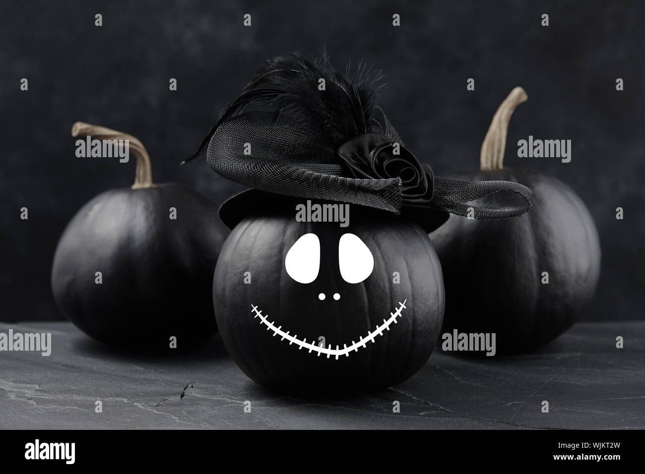 Halloween pumpkin jack o lantern with funny face on black background