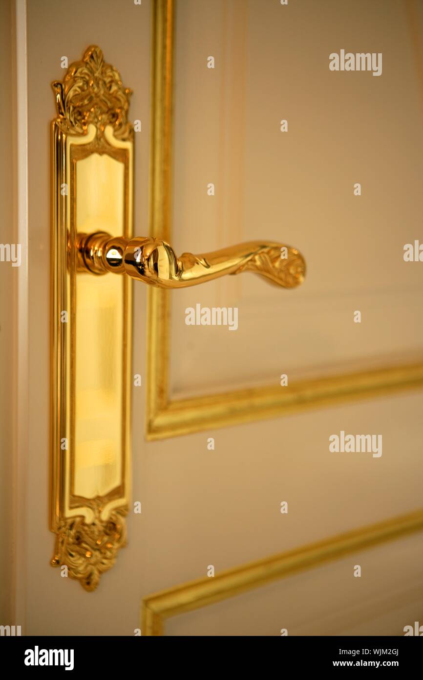 Golden door handle lock, white and gold door Stock Photo Alamy
