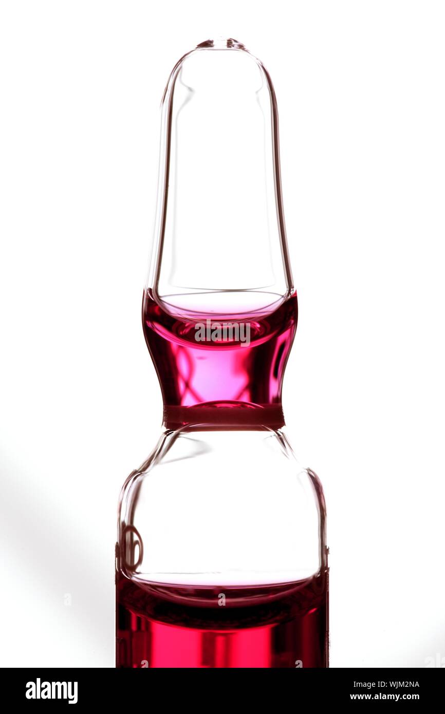Glass ampoule with red liquid medicine inside Stock Photo Alamy