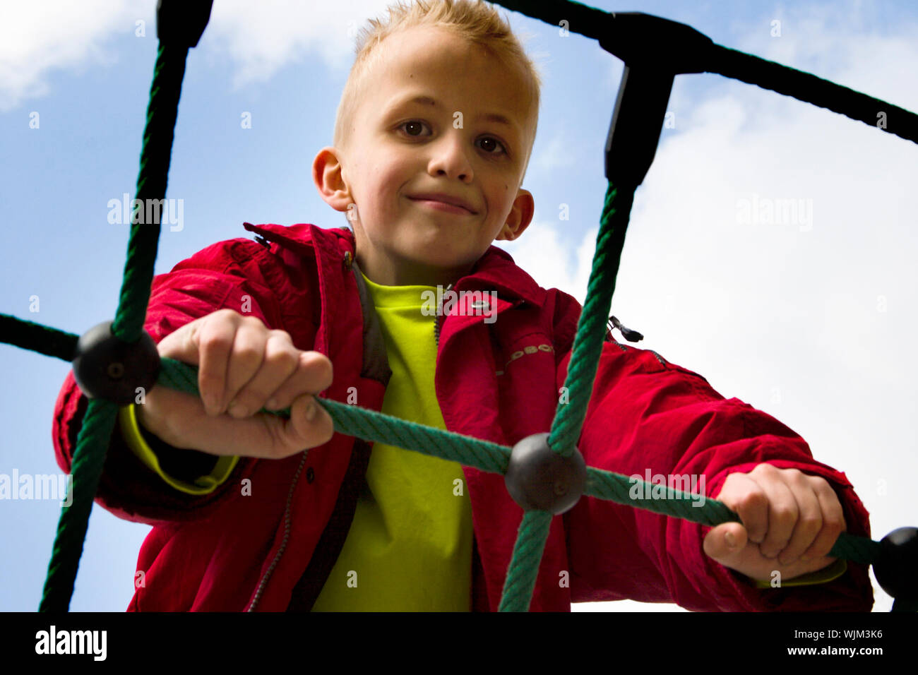 A young boy playing at the playground Stock Photo - Alamy