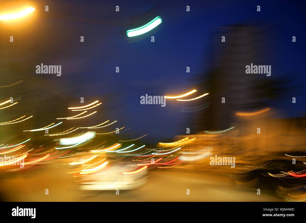 abstract blur city golden night lights, blue sky and traffic Stock Photo