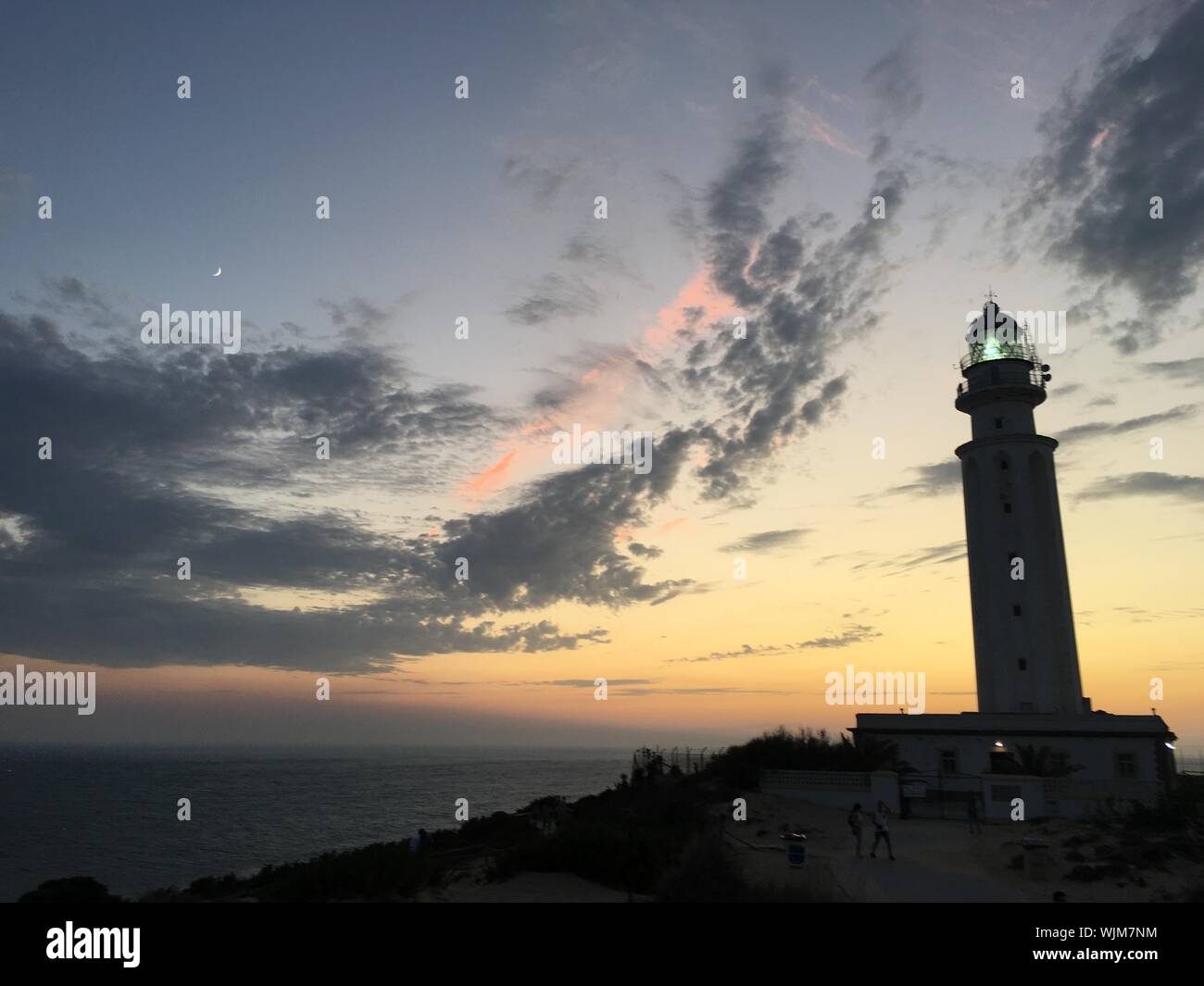 Trafalgar lighthouse on the coast of Cadiz at sunset Stock Photo