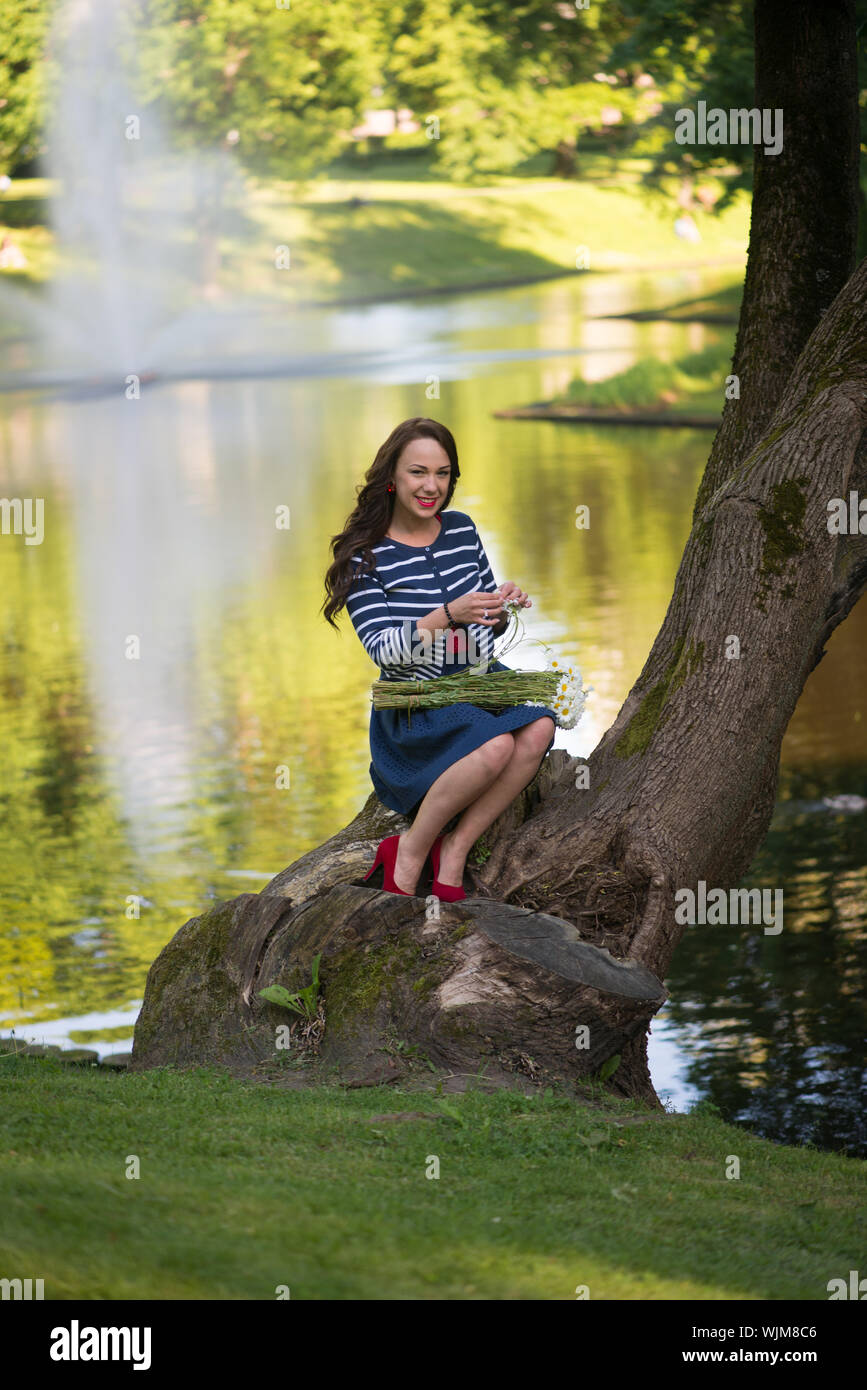 Woman Sitting Against Tree Trunk High Resolution Stock Photography And 