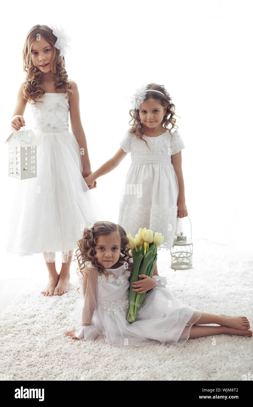 Beautiful little children wearing flower girl dresses posing with the bouquet of spring tulips Stock Photo Alamy