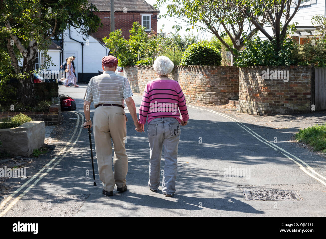 An elderly couple taking a walk holding hands Stock Photo