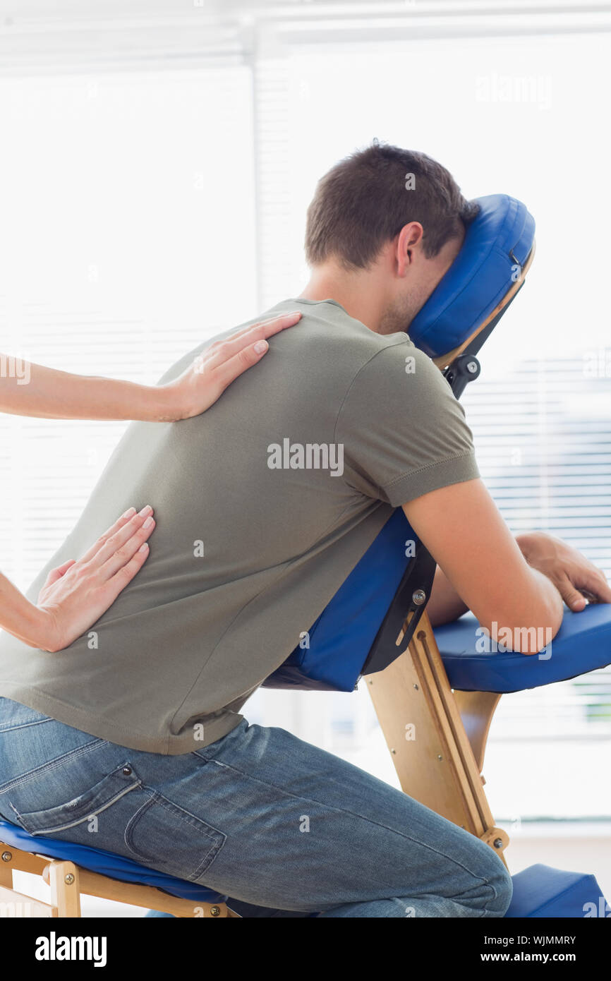 Cropped Image Of Therapist Giving Back Massage To Man On Massage Chair In Hospital Stock Photo Alamy
