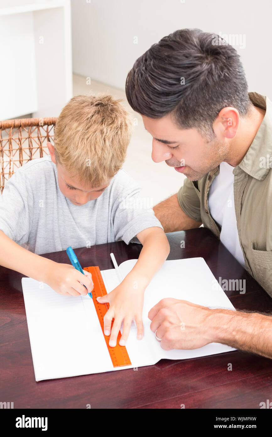 Father helping son with homework at table at home in kitchen Stock ...