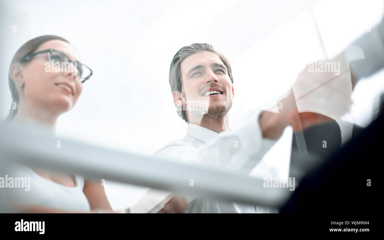 view from behind glass.handshake business people Stock Photo Alamy
