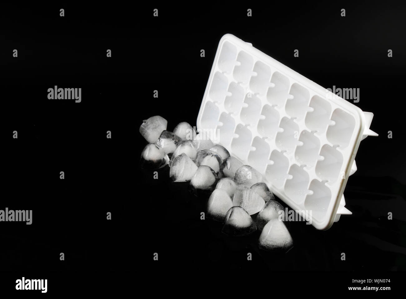Ice cube removed from the refrigerator. White Background Stock Photo
