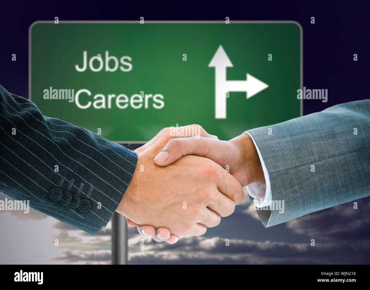 Composite image of business handshake against signpost showing the